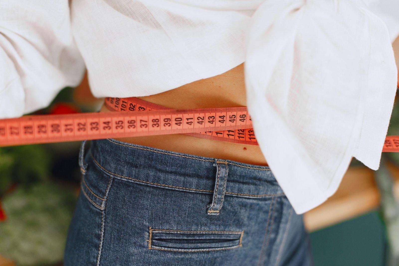 service-1-1 Person measuring waist with tape measure for weight loss progress